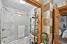 Full bath with bath / shower combo with glass door and ensuite bathroom