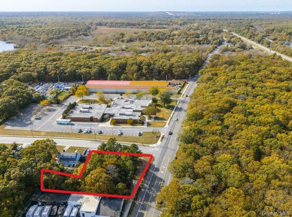 Aerial view of property's location with property boundaries highlighted and a large body of water