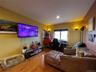 Living room with wood finished floors and recessed lighting