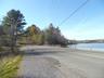 View of asphalt road featuring a water view
