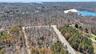 Drone / aerial view featuring a water view and a wooded view