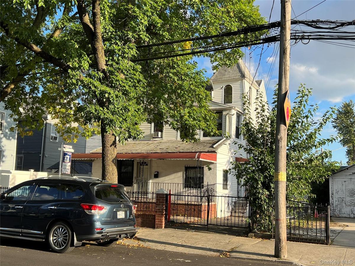 View of front of home featuring a fenced front yard and roof with shingles