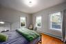 Bedroom with baseboard heating and light wood finished floors
