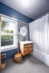 Full bath with vanity, shower / tub combo, and tile patterned floors