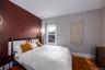 Bedroom featuring hardwood / wood-style flooring and baseboards