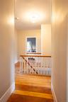 Staircase with hardwood / wood-style floors and baseboards