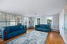 Living room featuring light wood-style flooring and a baseboard heating unit