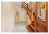Foyer entrance with light tile patterned floors and stairway