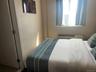 Bedroom featuring a wall mounted air conditioner