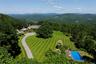 Drone / aerial view of a mountainous background and a pool area