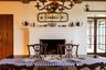 Dining space featuring a brick fireplace and a chandelier