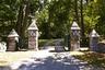View of dirt / gravel driveway with a gate and a gated entry