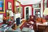 Living room with wood finished floors, a fireplace, arched walkways, and baseboards