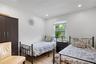 Bedroom with light wood finished floors and recessed lighting