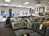 Living area with a paneled ceiling, carpet floors, and a wall mounted AC