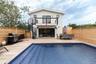 Back of house featuring stairway, outdoor dining space, a deck, and a balcony