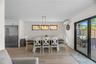 Dining room with light wood-style flooring and an AC wall unit