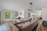 Dining area featuring light wood-style floors, stairs, and wooden ceiling