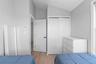 Bedroom featuring light wood-type flooring, a closet, and lofted ceiling
