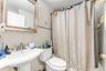Full bathroom featuring toilet, sink, tile walls, shower / bath combination with curtain, and decorative backsplash