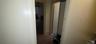 Hall with dark wood-type flooring