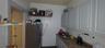 Kitchen featuring freestanding refrigerator, open shelves, and white cabinets