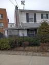 View of front facade featuring a fenced front yard and a chimney