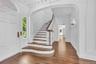 The Staircase located off to the side of the Center Hall to Allow the Clear Through-View from Front to Back