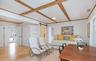 Bonus Room  with a barn door, light wood-type flooring, and ornamental molding