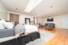Bedroom with a skylight and light wood-type flooring