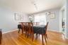 Dining area featuring light wood-style flooring, rail lighting, and ornamental molding