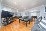 Living room with light wood finished floors and crown molding