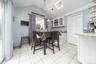 Dining area featuring a skylight and light tile patterned floors