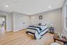 Bedroom with light wood-style floors, recessed lighting, and a closet
