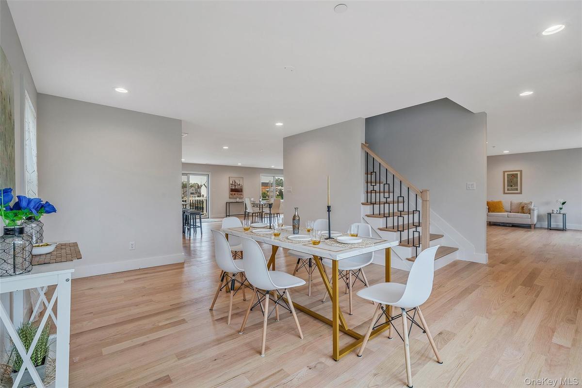 Dining room featuring light wood finished floors, stairway, and recessed lighting