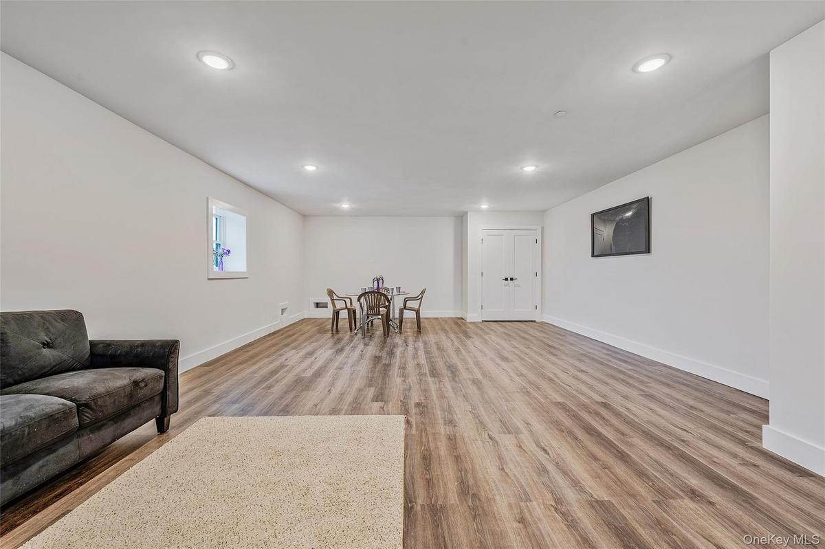 Living area with recessed lighting and light wood-style floors