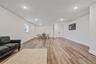 Living area with recessed lighting and light wood-style floors