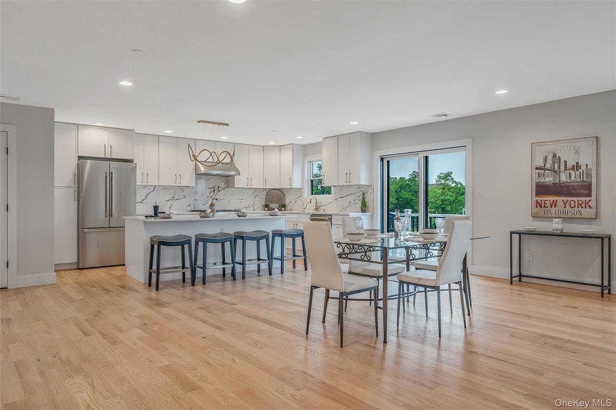 Dining room featuring light wood finished floors and recessed lighting