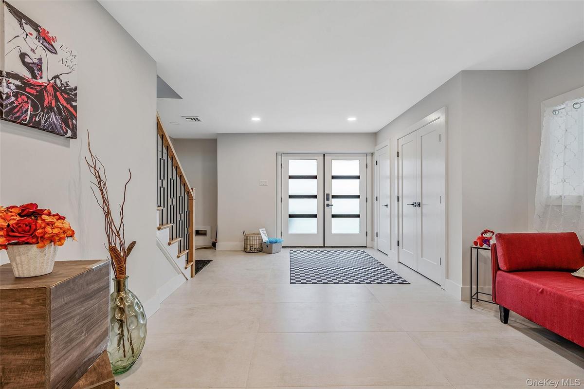 Foyer entrance featuring stairs, recessed lighting, and french doors
