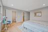 Bedroom featuring light wood-style flooring, recessed lighting, and connected bathroom