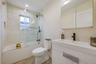 Full bath featuring vanity, shower / bath combination with glass door, and tile patterned flooring