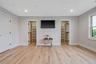 Living area with wood finished floors and recessed lighting
