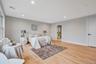 Bedroom with light wood-style floors, recessed lighting, and ensuite bath