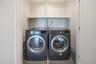 Washroom with washer and dryer and tile patterned flooring