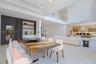 Formal dining with custom cabinetry a bar area.
