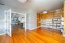 The top floor includes a private conference room with French doors, a reception area, kitchen, bathroom, and two offices. With direct rooftop access, 