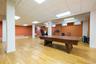 Spacious basement with a stage area, two bathrooms, one shower, a utility room, and a large storage room, offering flexible space for a variety of use