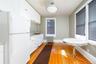 The top floor includes a kitchen conveniently located near the rooftop access door. This level has the potential to operate as a separate business sui