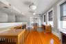 The top floor reception area can easily function as additional office space and features beautiful lighting with updated hardwood floors throughout. T