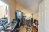 Carpeted office with lofted ceiling